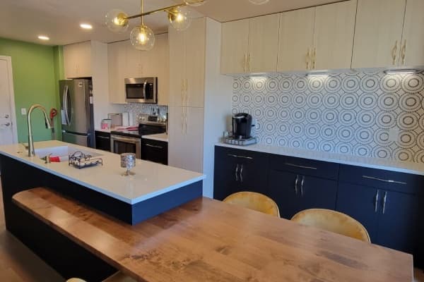 Kitchen remodel — cabinets, quartz counters, tile backsplash and new lighting.